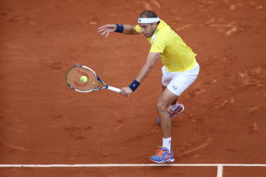 Professional tennis player Gilles Muller of Luxembourg in action during his second round match at Roland Garros