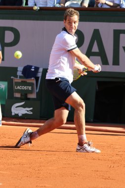 Professional tennis player Richard Gasquet of France in action during his third round match at Roland Garros 2015 clipart