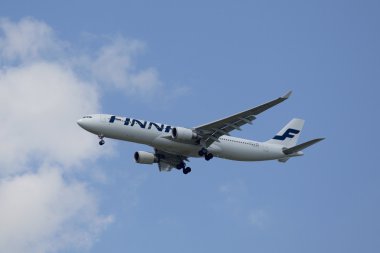 Finnair Airbus 320 descending for landing at JFK International Airport in New York clipart