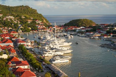 St. Barts 'taki Gustavia Limanı' nın 19 Nisan 2024 tarihli havadan görünüşü sayısız mega yat sergilenmektedir. Ada, kış tatili döneminde popüler bir turizm merkezidir.