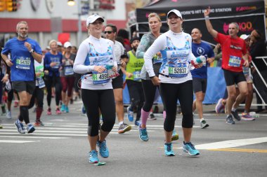 New York City Marathon runners traverse 26.2 miles through all five NYC borough clipart