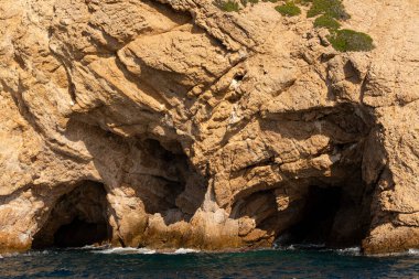 Thassos Adası 'nın kıyı şeridi. Yunanistan 'daki deniz manzarası. Kayalar, deniz, ağaçlar, gökyüzü.