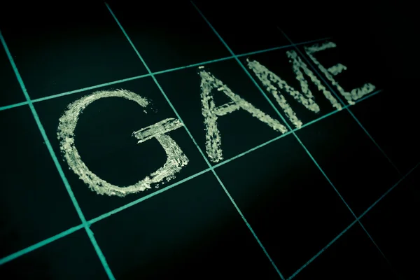 Game word handwritten on black chalkboard — Stock Photo, Image