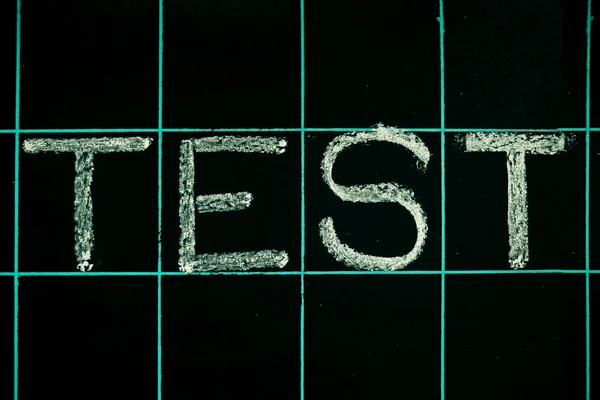 Test word handwritten on black chalkboard — Stock Photo, Image