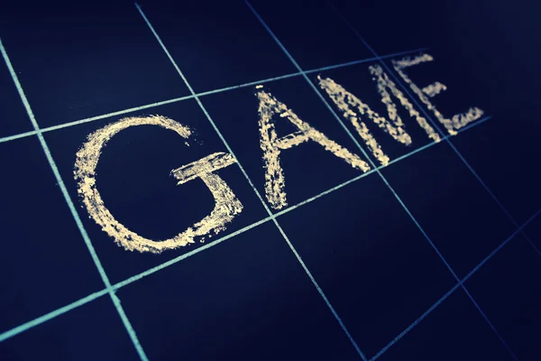 Game word handwritten on black chalkboard — Stock Photo, Image