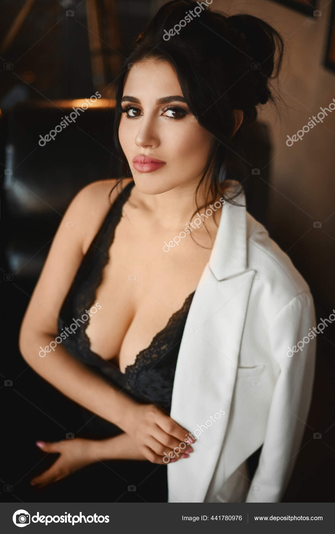 Beautiful Busty Naked Latinas - Portrait of the sexy Latino woman with big breasts in a black sexy outfit  looking in the camera. Busty model woman with bright makeup and full lips  Stock Photo by Â©innarevyako 441780976