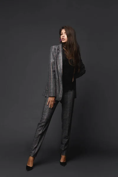 회색빛 배경, 비즈니스 패션 컨셉에서 회색 옷을 입은 자신감 있는 모델 소녀의 전체 사진 — 스톡 사진