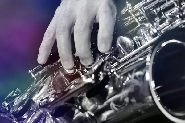 saxophone and musician hand, closeup