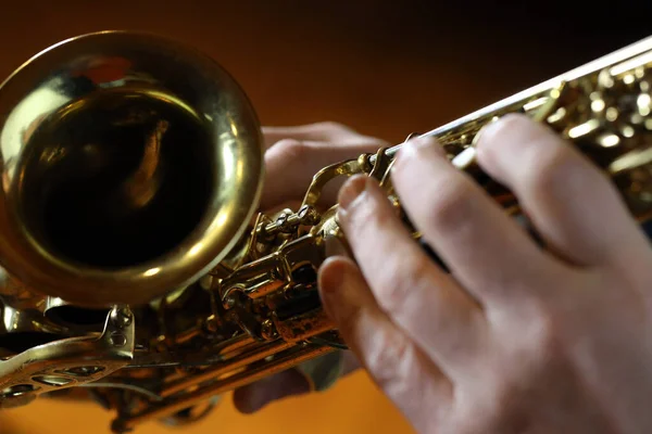 saxophone and musician hand, closeup