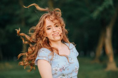 Parkta hareketli neşeli bir kadın saç ve duygu geliştiriyor.