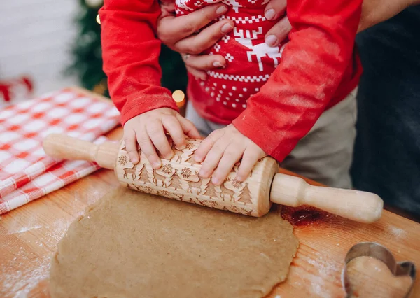 rolling dough rolling pin with christmas symbols cooking cookies kids hand