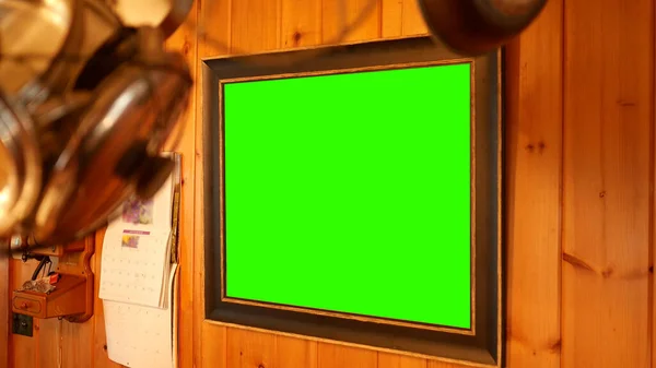 A Green Screen Picture Frame on Wooden Wall in Kitchen