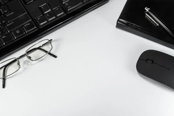 Notebook with a pen, telephone and computer on a white backgroun — Stock Photo, Image