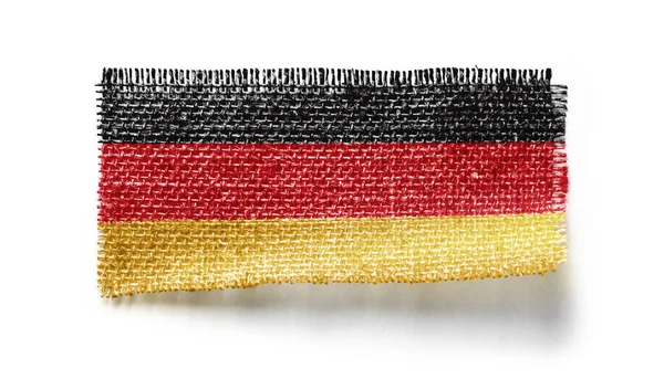 Germany flag on a piece of cloth on a white background — Stock Photo, Image