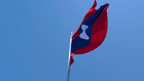 La bandera nacional de Laos ondea en el viento — Vídeos de Stock