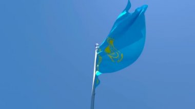 Kazakistan 'ın ulusal bayrağı mavi gökyüzüne karşı rüzgarda dalgalanıyor.