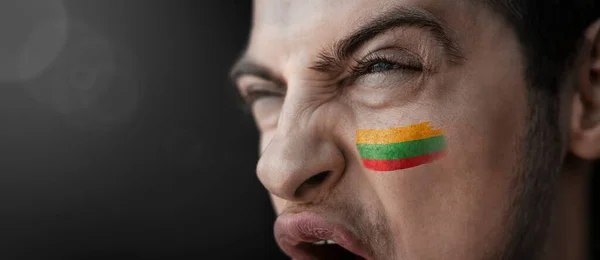 Ein schreiender Mann mit dem Bild der Landesflagge auf dem Gesicht — Stockfoto
