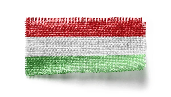 Bandera de Hungría sobre un trozo de tela sobre un fondo blanco —  Fotos de Stock