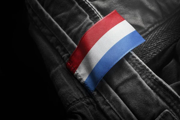 Tag on dark clothing in the form of the flag of the Netherlands — Stock Photo, Image