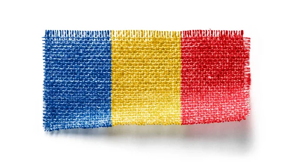 Bandiera ciadiana su un pezzo di stoffa su sfondo bianco — Foto Stock