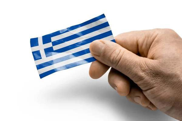 Hand holding a card with a national flag the Greece — Stock Photo, Image