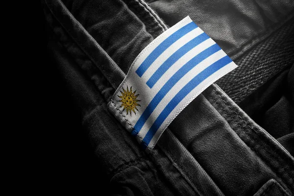 Markering op donkere kleding in de vorm van de vlag van Uruguay — Stockfoto