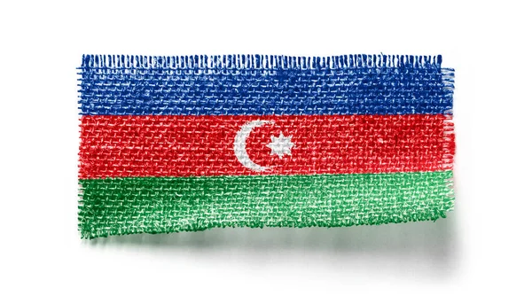 Azerbajdzjan flagga på ett tygstycke på en vit bakgrund — Stockfoto