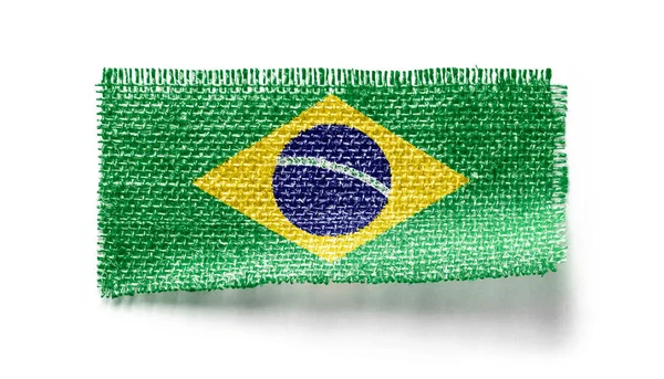 Bandeira do Brasil em um pedaço de pano em um fundo branco — Fotografia de Stock