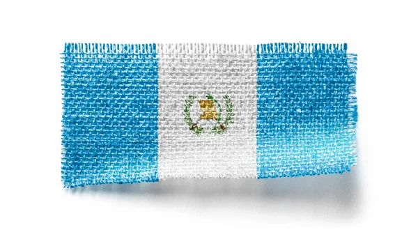 Bandera de Guatemala sobre un trozo de tela sobre fondo blanco — Foto de Stock