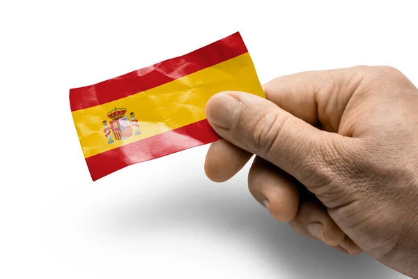 Рука держит карту с национальным флагом Испании — стоковое фото