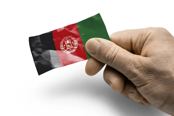 Mano sosteniendo una tarjeta con una bandera nacional el Afganistán — Foto de Stock