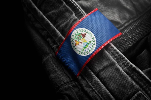 Koyu renk elbiseleri Belize bayrağı şeklinde etiketle. — Stok fotoğraf
