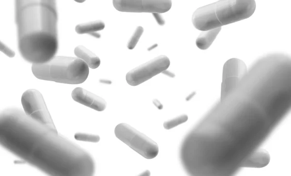 Κάψουλες με το φάρμακο αιωρείται σε λευκό φόντο — Φωτογραφία Αρχείου