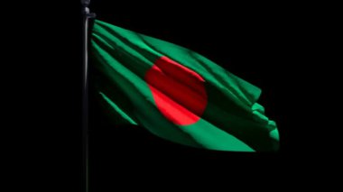 Bangladeş 'in ulusal bayrağı siyah bir arka plana karşı rüzgarda dalgalanıyor.