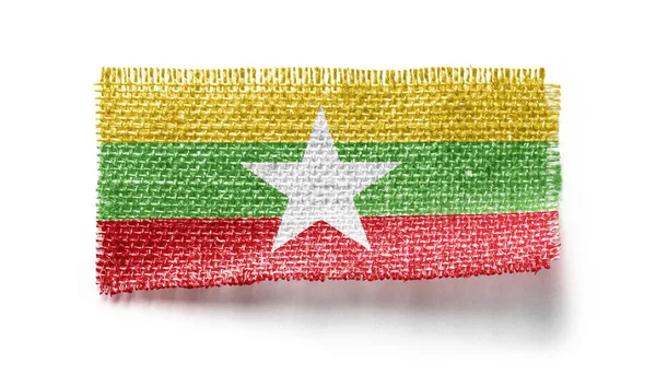 Bandera de Myanmar sobre un trozo de tela sobre un fondo blanco — Foto de Stock