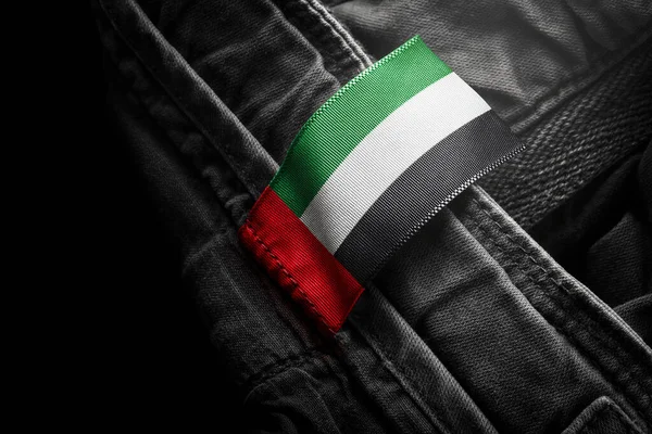 Etiqueta de la ropa oscura en forma de bandera de los Emiratos Árabes Unidos —  Fotos de Stock