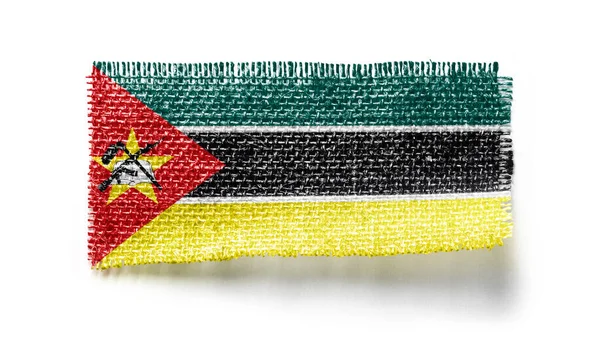 Bandera de Mozambique sobre un trozo de tela sobre un fondo blanco — Foto de Stock