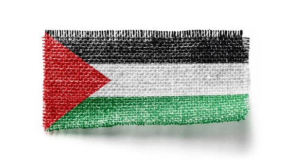흰 배경에 천 조각 위에 팔레스타인 국기를 게양하는 모습 — 스톡 사진