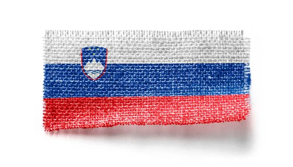 Slovenia bandiera su un pezzo di stoffa su sfondo bianco — Foto Stock