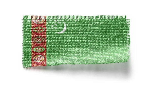 Bandeira do Turquemenistão em um pedaço de pano em um fundo branco — Fotografia de Stock