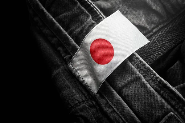 Tag on dark clothing in the form of the flag of the Japan — Stock Photo, Image
