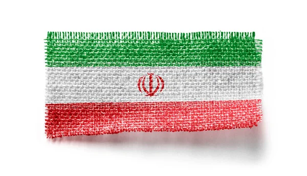 Bandera de Irán sobre un trozo de tela sobre un fondo blanco —  Fotos de Stock