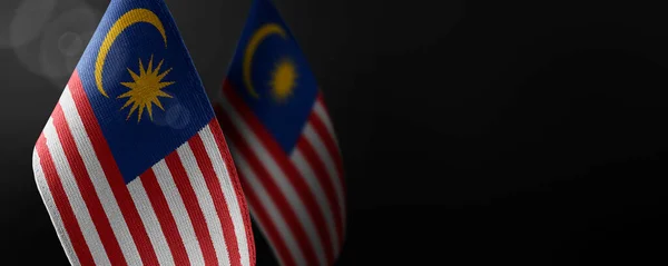 Small national flags of the Malaysia on a dark background — Stock Photo, Image