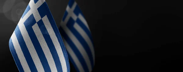 Small national flags of the Greece on a dark background — Stock Photo, Image