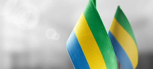 Small national flags of the Gabon on a light blurry background — Stock Photo, Image