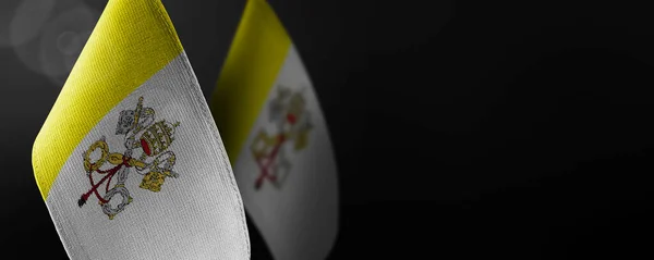 Small national flags of the Vatican on a dark background — Stock Photo, Image