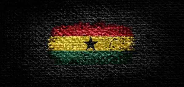 A ghánai nemzeti zászló a sötét anyagon — Stock Fotó