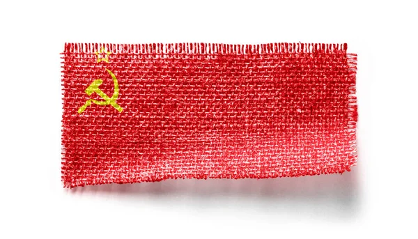 Σημαία ΕΣΣΔ σε ένα κομμάτι ύφασμα σε λευκό φόντο — Φωτογραφία Αρχείου
