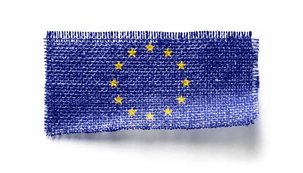 Flagge der Europäischen Union auf einem Stück Stoff auf weißem Hintergrund — Stockfoto