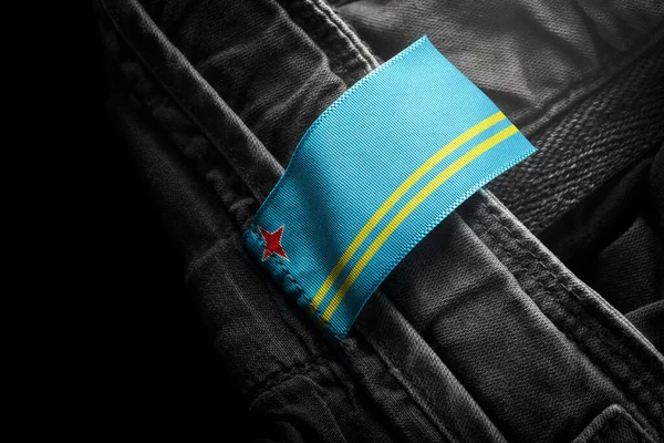 Tag on dark clothing in the form of the flag of the Aruba — Stock Photo, Image
